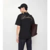 T-shirt in cotone con logo in corsivo a quadri